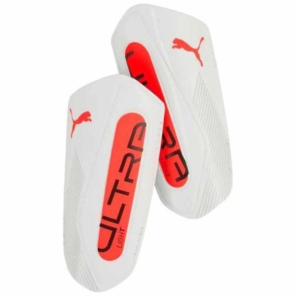 Puma Ultra Light siksnas futbola aizsargi, baltā un oranžā krāsā Puma Ultra Light siksnas futbola aizsargi, baltā un oranžā krāsā